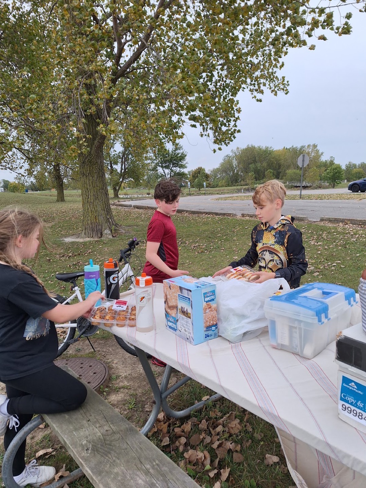 Students with their bikes gathered around the snack table at the bike-a-thon